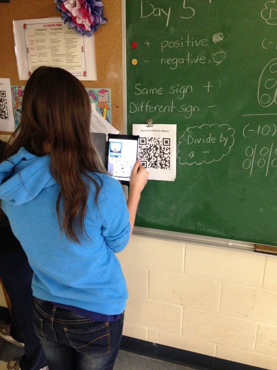 girl using iPad to scan a QR code to quickly get to a website